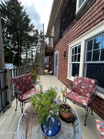 a view of a chairs and table in backyard