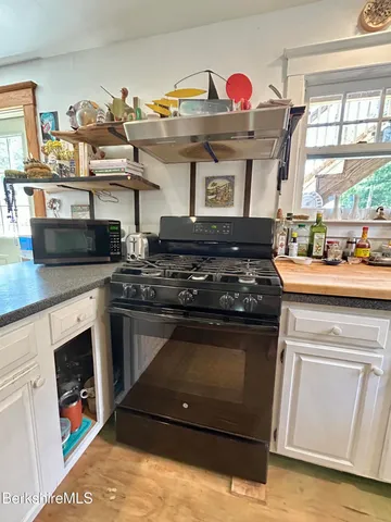 a kitchen with stainless steel appliances granite countertop a stove and a sink