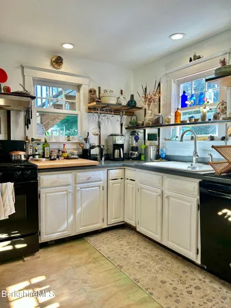 a kitchen with stainless steel appliances granite countertop a sink and cabinets