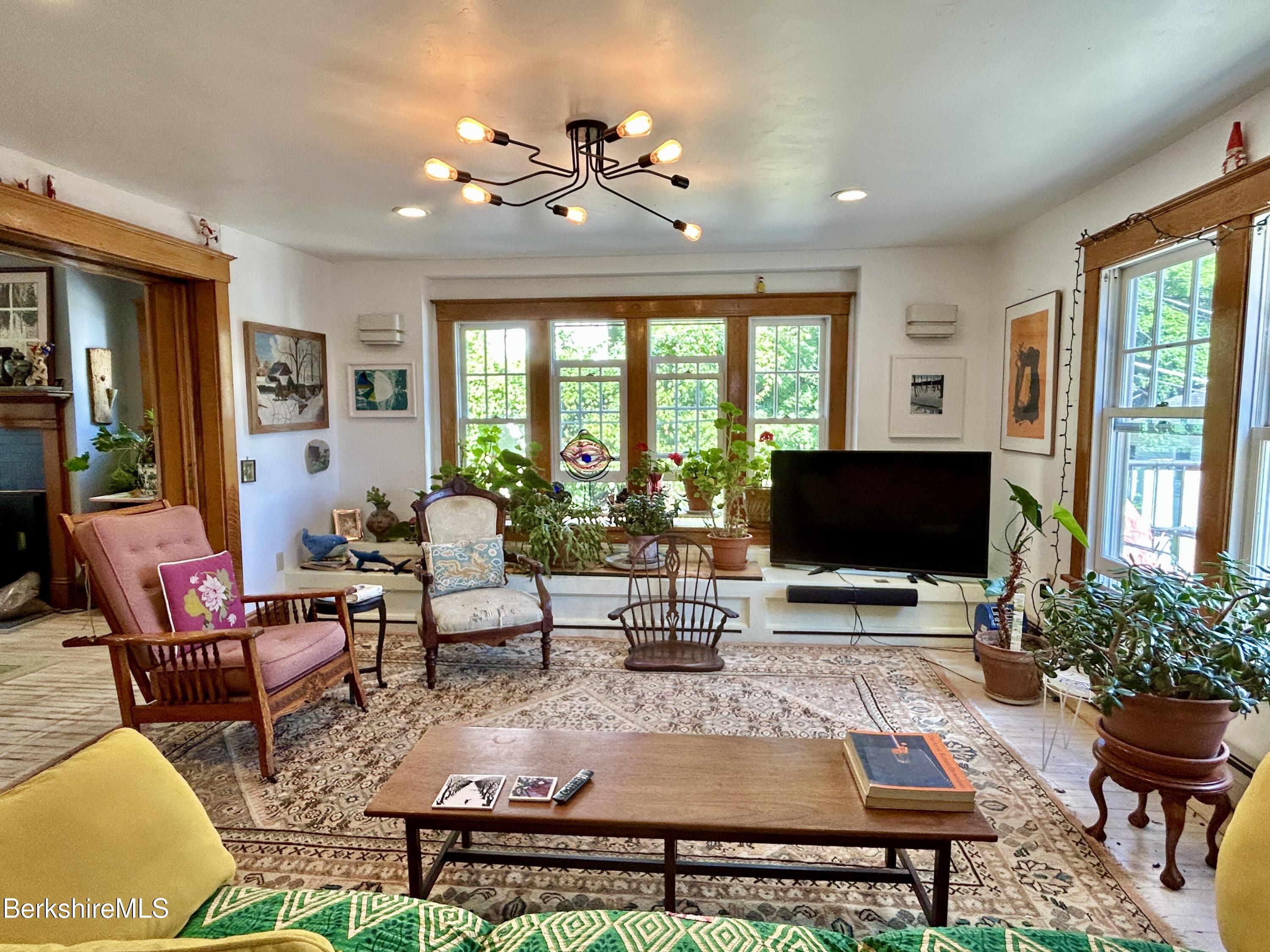 96 East Quincy Street North Adams, MA 01247 - Photo 8 of 16 a living room with furniture a flat screen tv and a large window