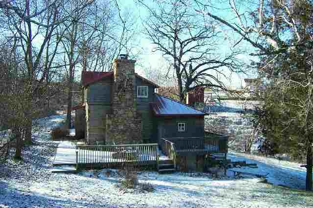 a view of house with a yard and sitting area