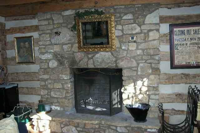 412 East Burke Road Elizabeth, IL 61028 - Photo 7 of 9 a fireplace with a chair and a fireplace