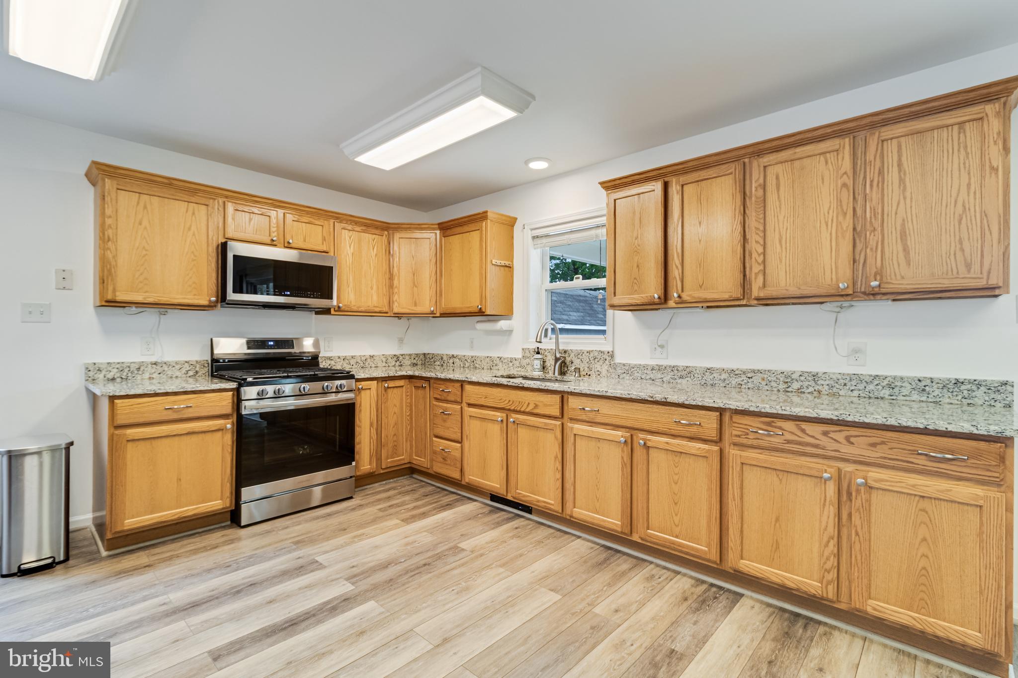 12015 Woodbury Road Nanjemoy, MD 20662 - Photo 8 of 53 a kitchen with stainless steel appliances granite countertop a stove top oven a sink dishwasher and granite countertops with wooden floor