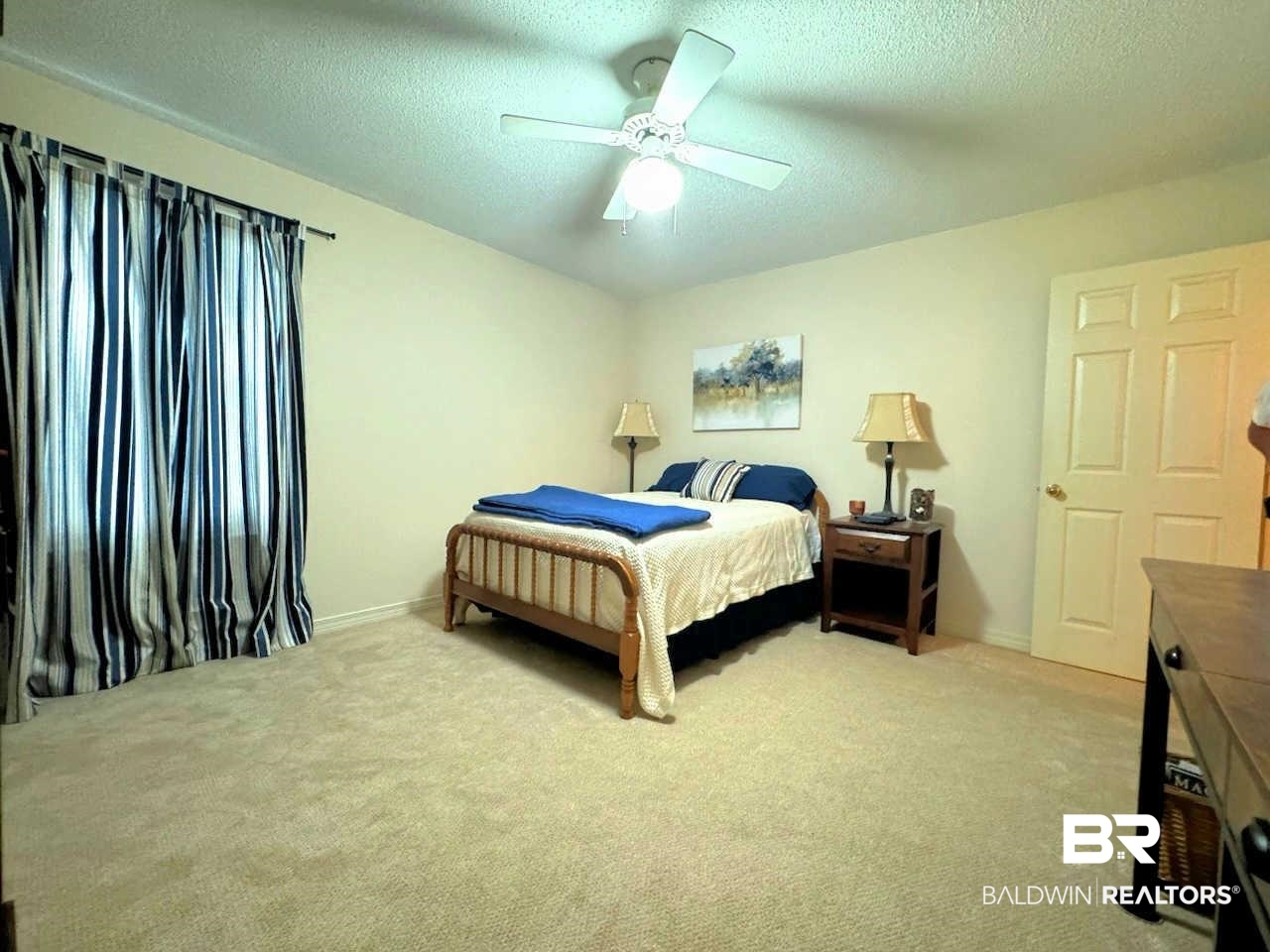 31163 Woodland Way Daphne, AL 36527 - Photo 29 of 44 Bedroom featuring ceiling fan, a textured ceiling, and light carpet