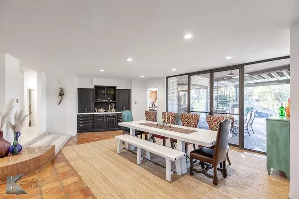 a living room with furniture a rug and a large window