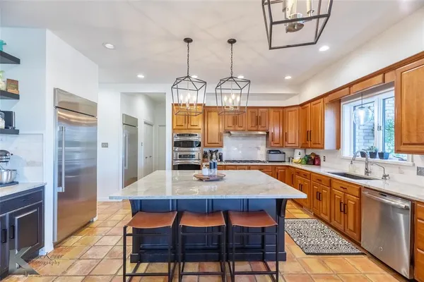 a kitchen with a dining table and chairs