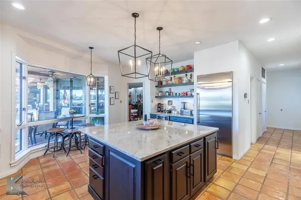 a kitchen with stainless steel appliances granite countertop counter space and wooden floor