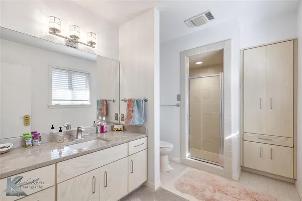 a bathroom with a sink a vanity and a mirror