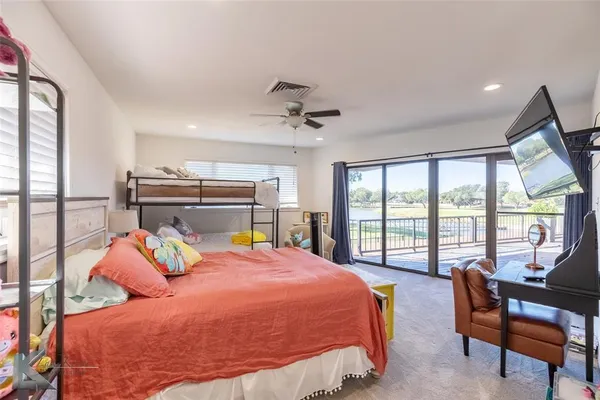 a bedroom with a bed and a large window