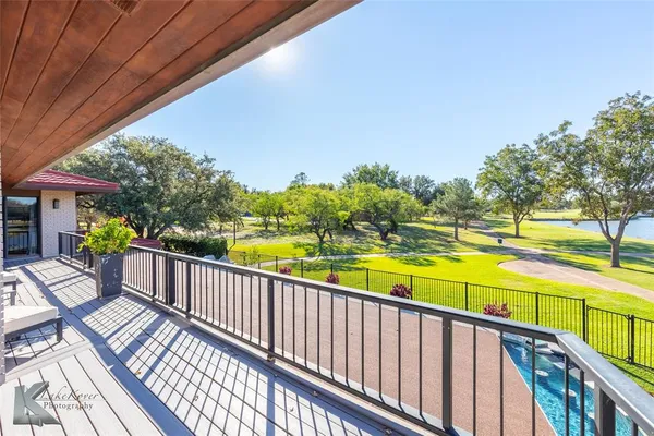 a view of a balcony with wooden floor and outdoor space