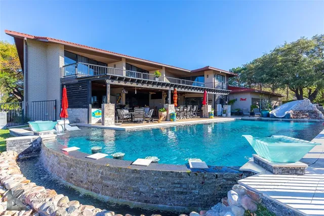 a view of swimming pool with a table and chairs