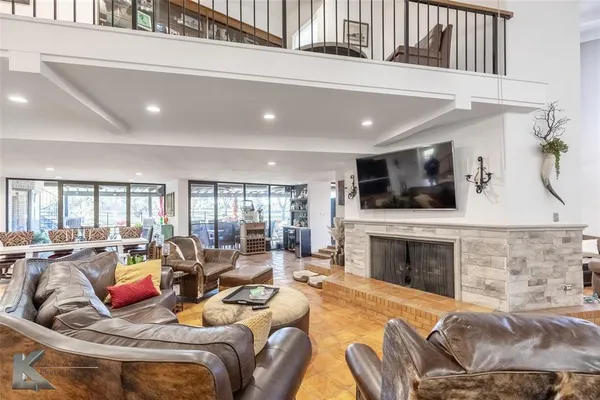 a living room with furniture large window and a fireplace