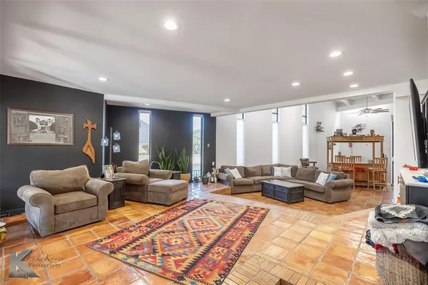 a living room with furniture rug and window