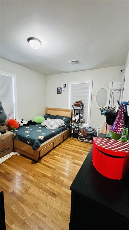 76 Eleanor Street, Unit 3 Chelsea, MA 02150 - Photo 4 of 9 a living room with furniture pool table and gym equipment