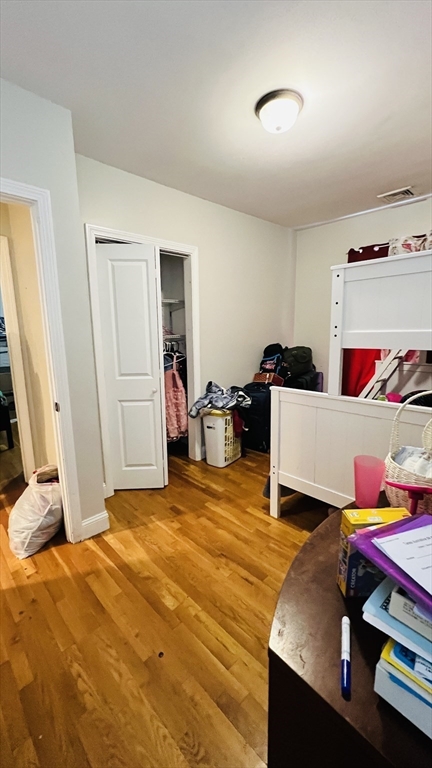 76 Eleanor Street, Unit 3 Chelsea, MA 02150 - Photo 8 of 9 a bed room with a bed and a desk