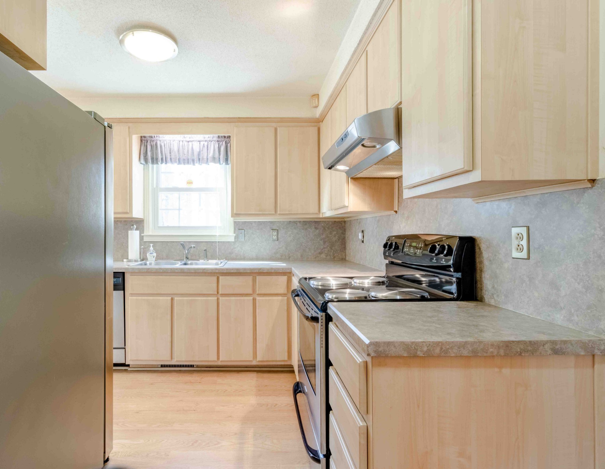 4316 Memory Lane Adams, TN 37010 - Photo 11 of 45 a kitchen with granite countertop white cabinets and white appliances