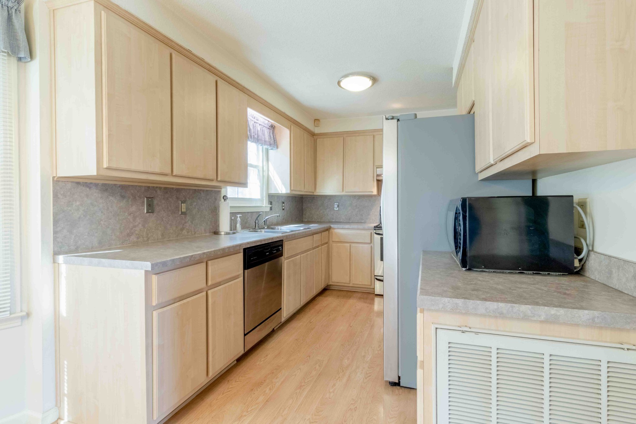 4316 Memory Lane Adams, TN 37010 - Photo 12 of 45 a kitchen with a microwave stove top oven and cabinets