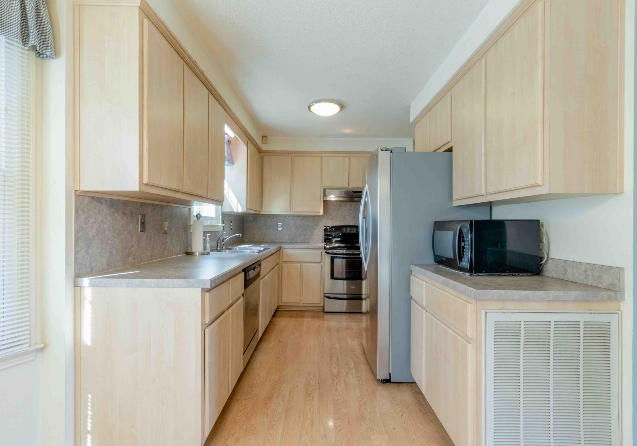4316 Memory Lane Adams, TN 37010 - Photo 13 of 45 a kitchen with stainless steel appliances a stove a sink a microwave and cabinets