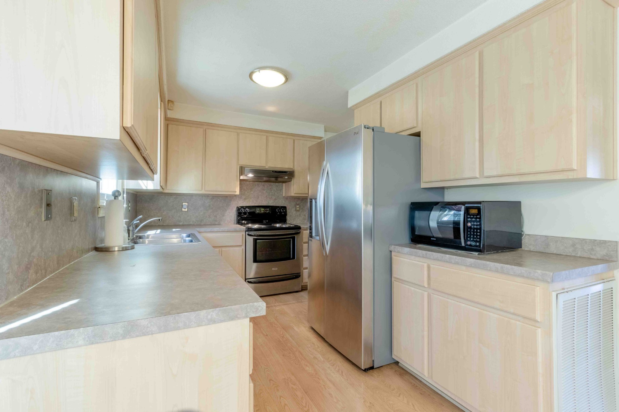 4316 Memory Lane Adams, TN 37010 - Photo 14 of 45 a kitchen with stainless steel appliances granite countertop a sink a stove a refrigerator a granite counter tops and white cabinets