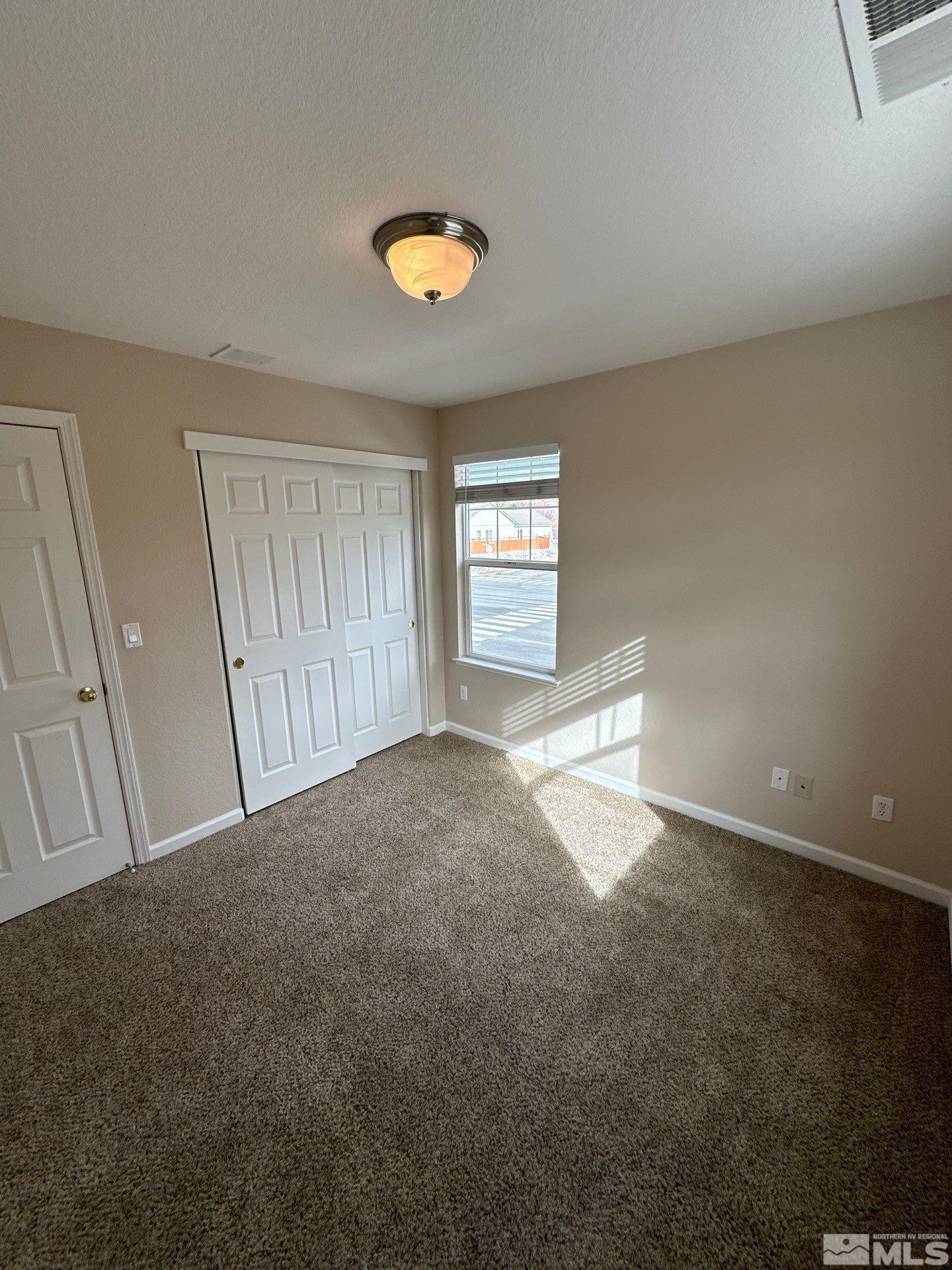 3994 Dominus Drive Sparks, NV 89436 - Photo 11 of 18 a view of empty room with windows