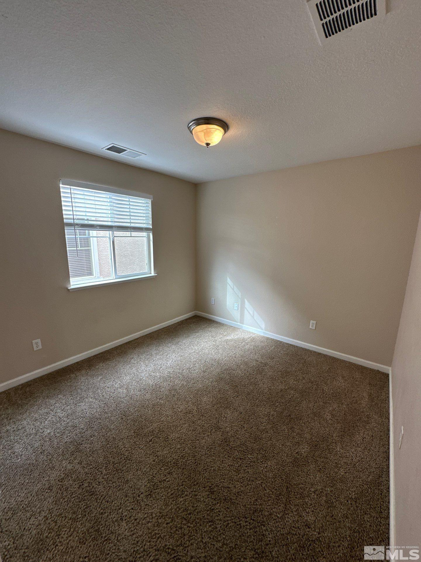 3994 Dominus Drive Sparks, NV 89436 - Photo 13 of 18 an empty room with a empty space and a window