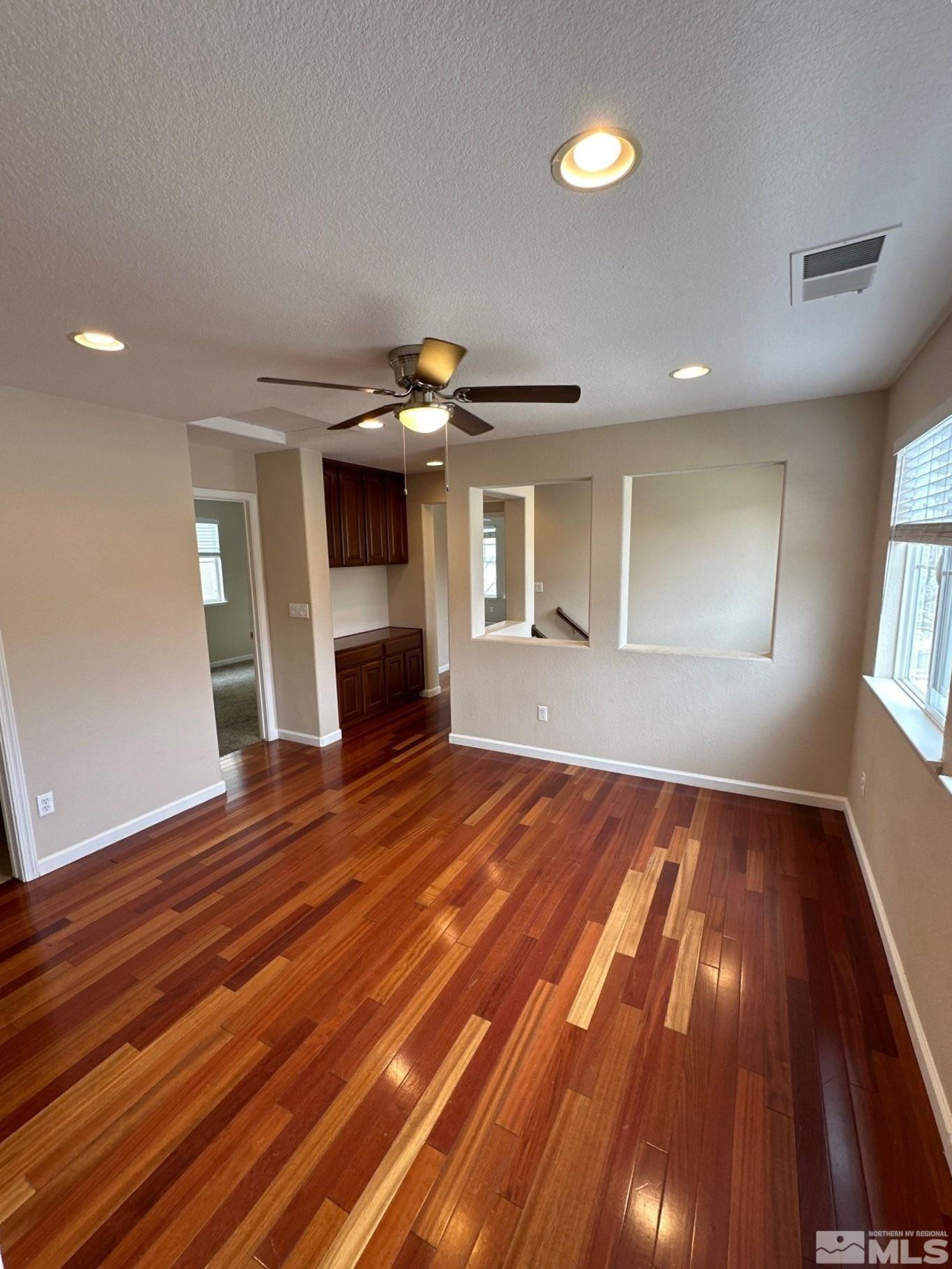 3994 Dominus Drive Sparks, NV 89436 - Photo 3 of 18 a view of empty room with wooden floor and fan
