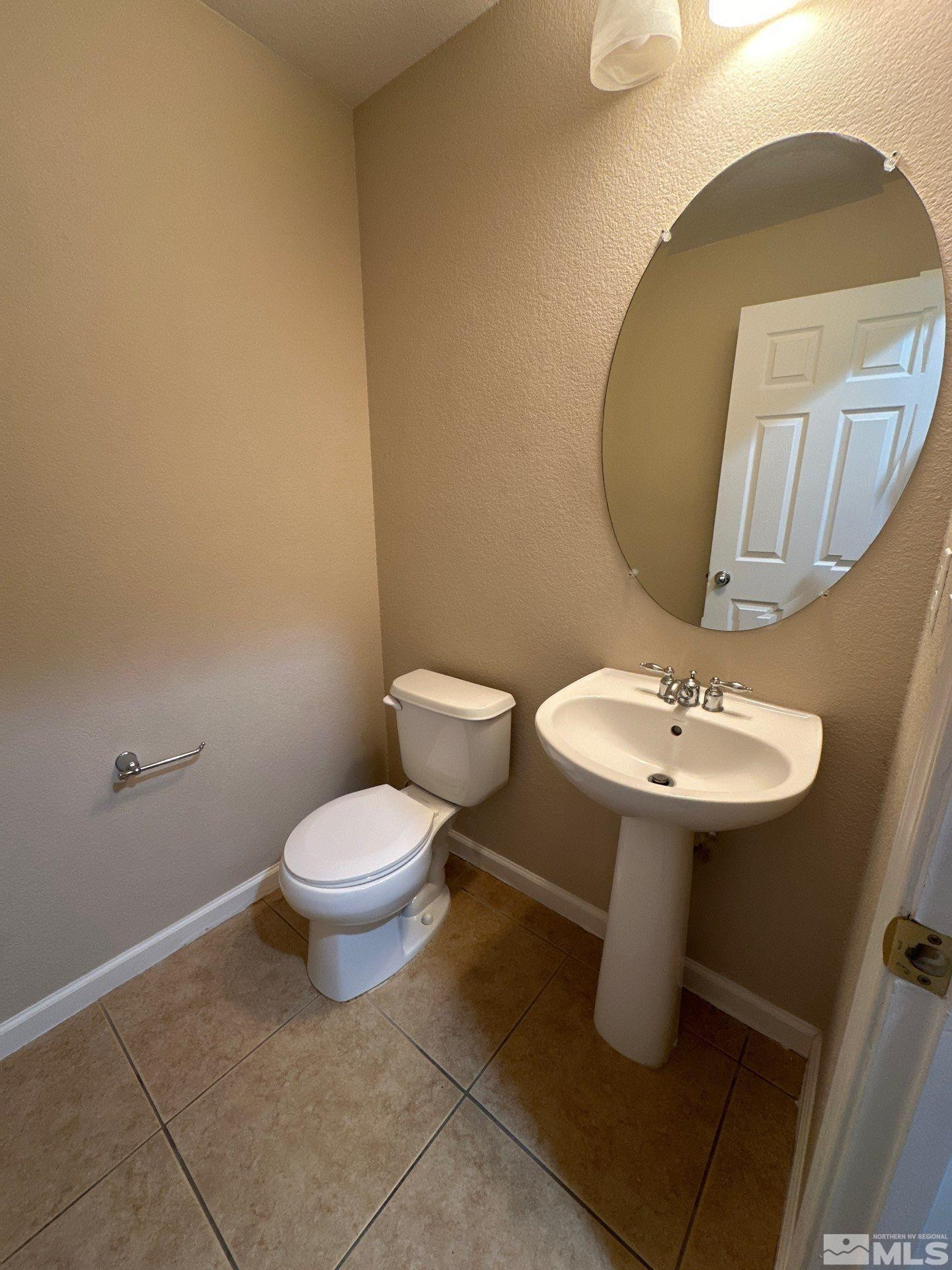 3994 Dominus Drive Sparks, NV 89436 - Photo 7 of 18 a bathroom with a sink and a mirror