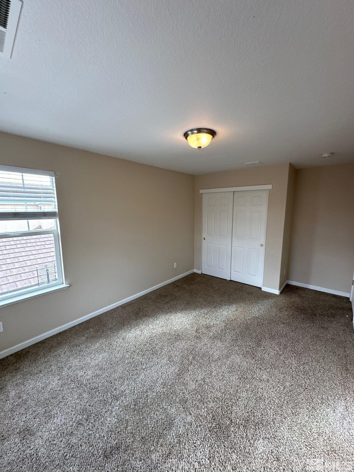 3994 Dominus Drive Sparks, NV 89436 - Photo 9 of 18 an empty room with a window and pillar in it