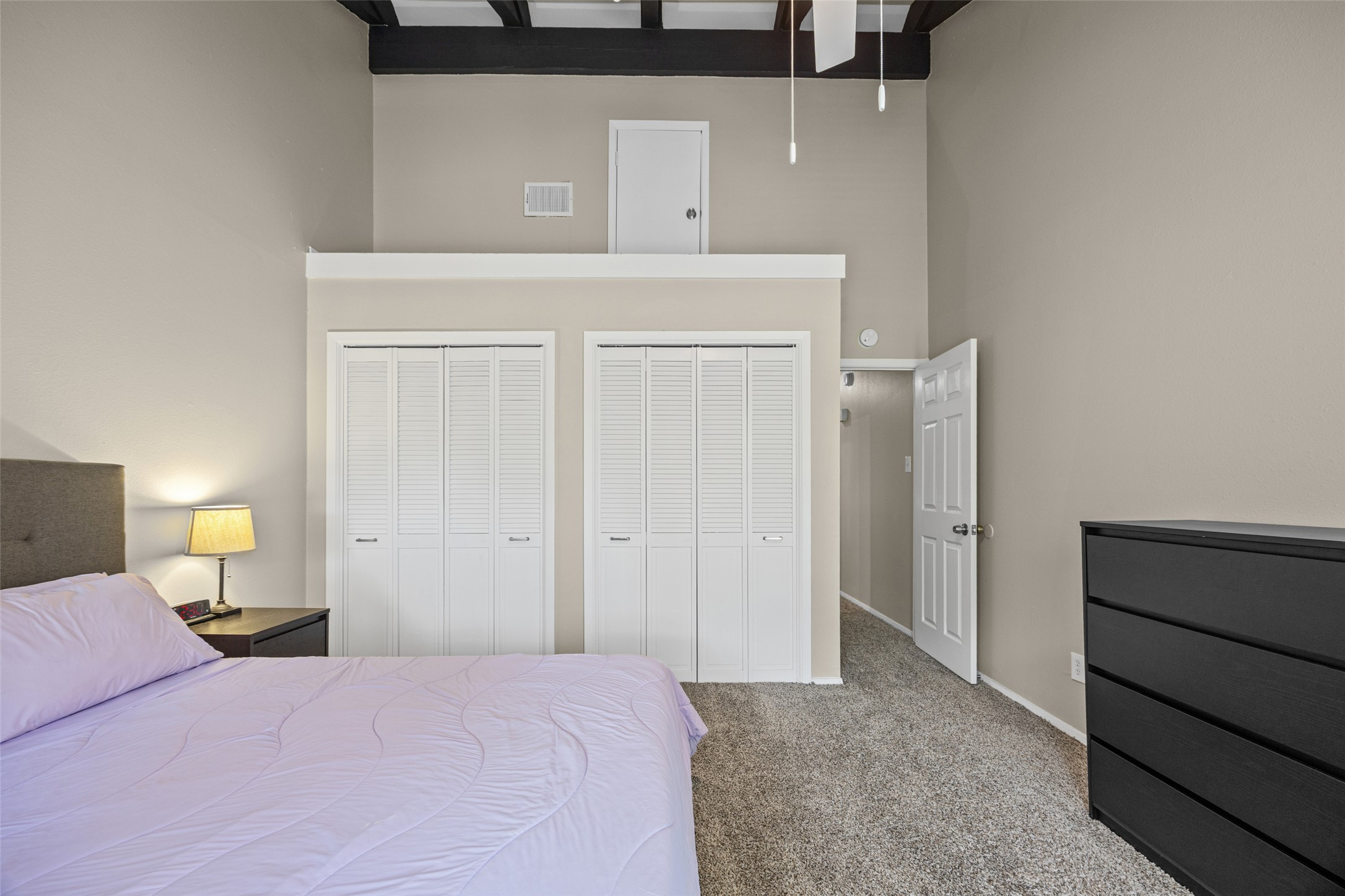 3809 Menchaca Road, Unit C Austin, TX 78704 - Photo 17 of 28 A cozy bedroom with a lofty ceiling and convenient closet storage.