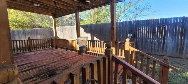 a view of deck with wooden floor and wooden fence