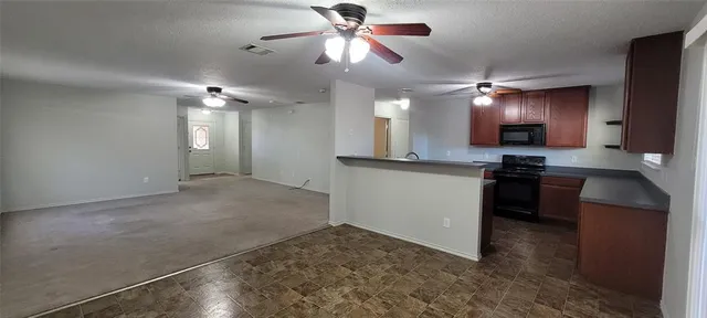 a view of kitchen with microwave and stove