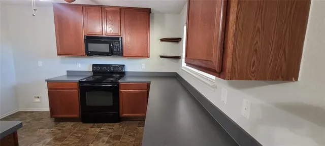 a kitchen with cabinets a sink and appliances