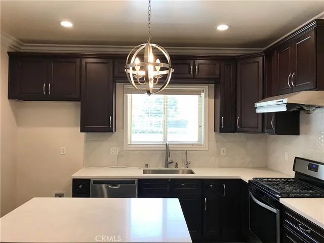 a kitchen with a sink and a stove top oven