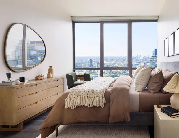 a bedroom with a large bed and a large window