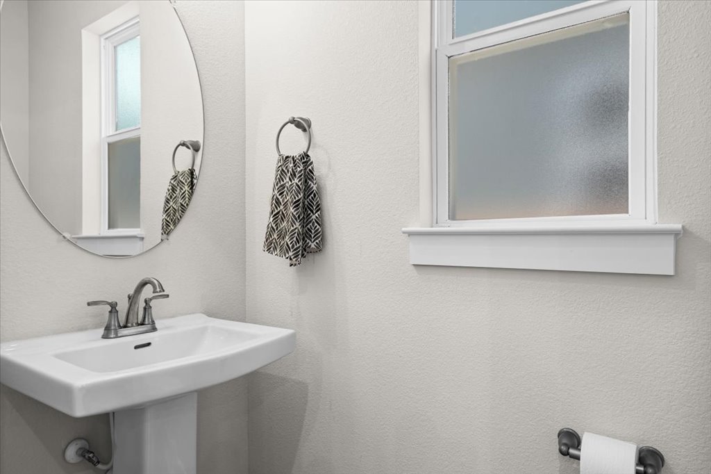 6416 Cowman Way Austin, TX 78747 - Photo 12 of 30 a bathroom with a sink and mirror