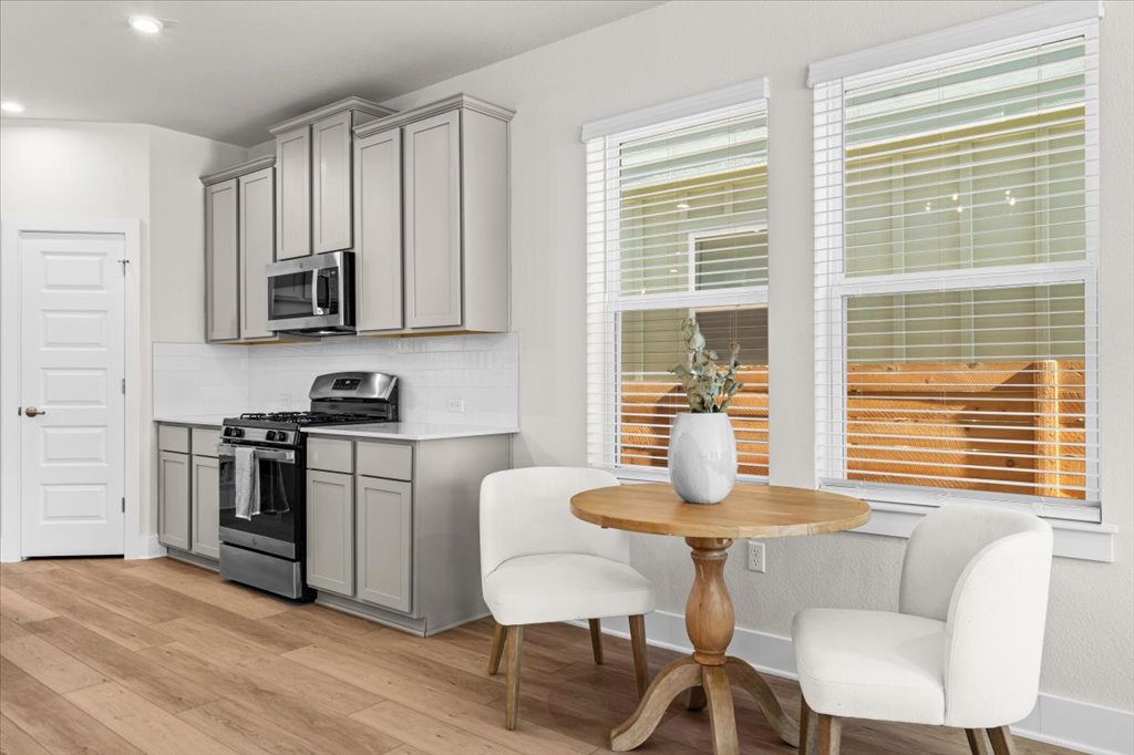 6416 Cowman Way Austin, TX 78747 - Photo 6 of 30 a kitchen with stainless steel appliances granite countertop a table and chairs