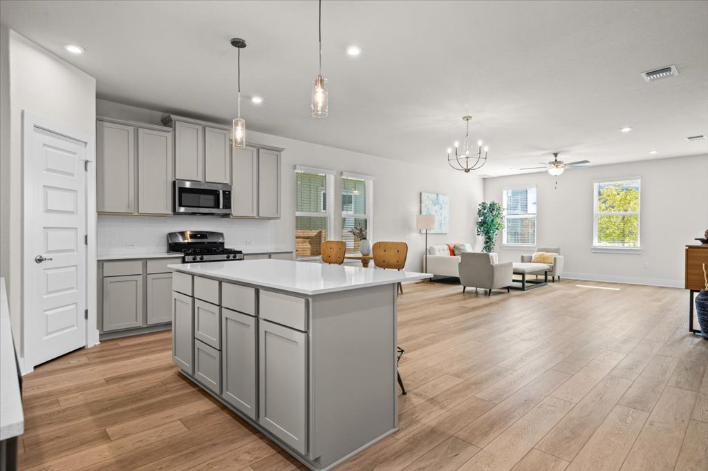 6416 Cowman Way Austin, TX 78747 - Photo 8 of 30 a large kitchen with stainless steel appliances lots of counter top space