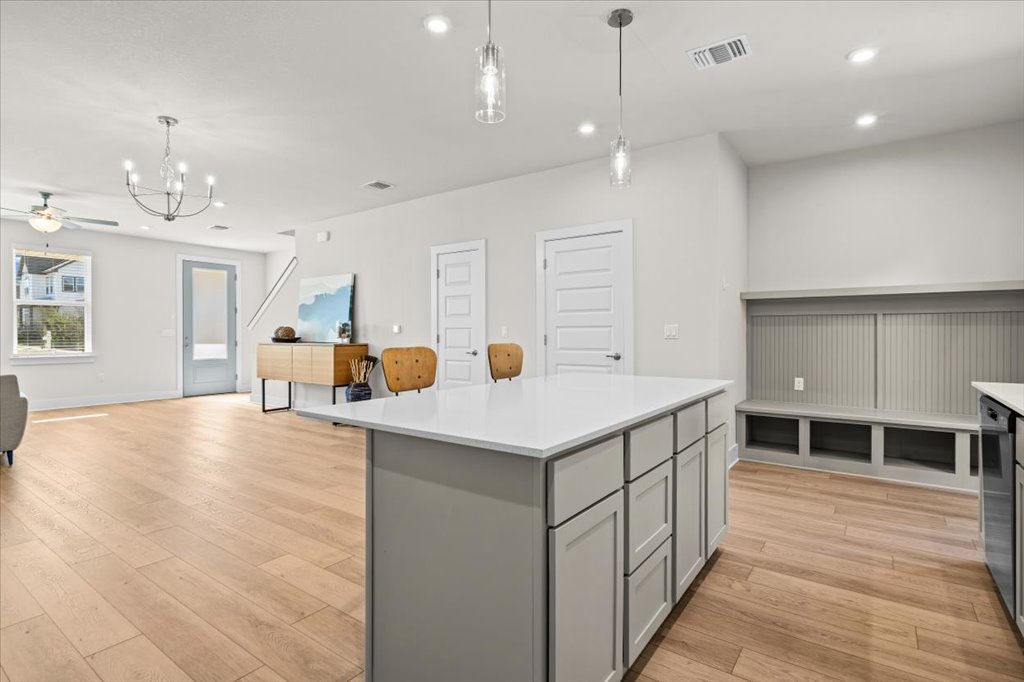 6416 Cowman Way Austin, TX 78747 - Photo 9 of 30 a kitchen with a stove a refrigerator and a dining table with wooden floor