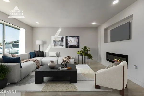a living room with furniture a large window and a fireplace