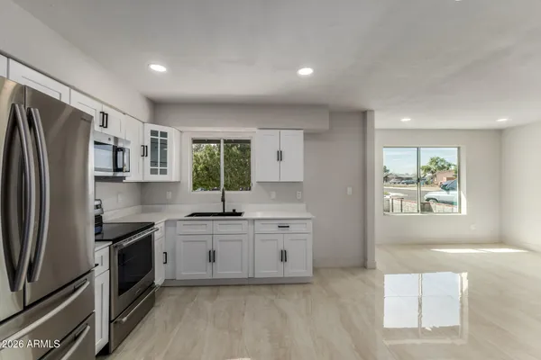 a kitchen with stainless steel appliances a sink stove and refrigerator