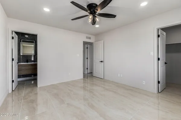 a view of an empty room and kitchen view