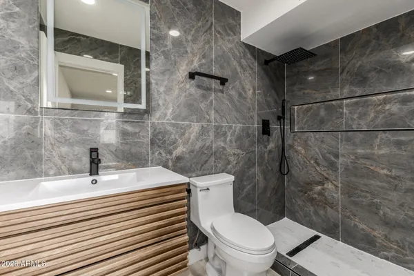 a bathroom with a sink toilet and shower