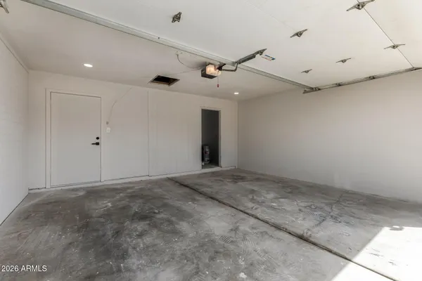 an empty room with projector and a ceiling fan
