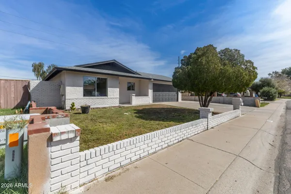 a view of a house with backyard and sitting area