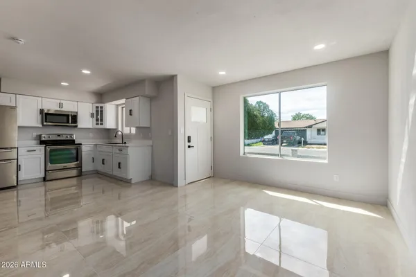 a view of a kitchen with a sink dishwasher and a microwave