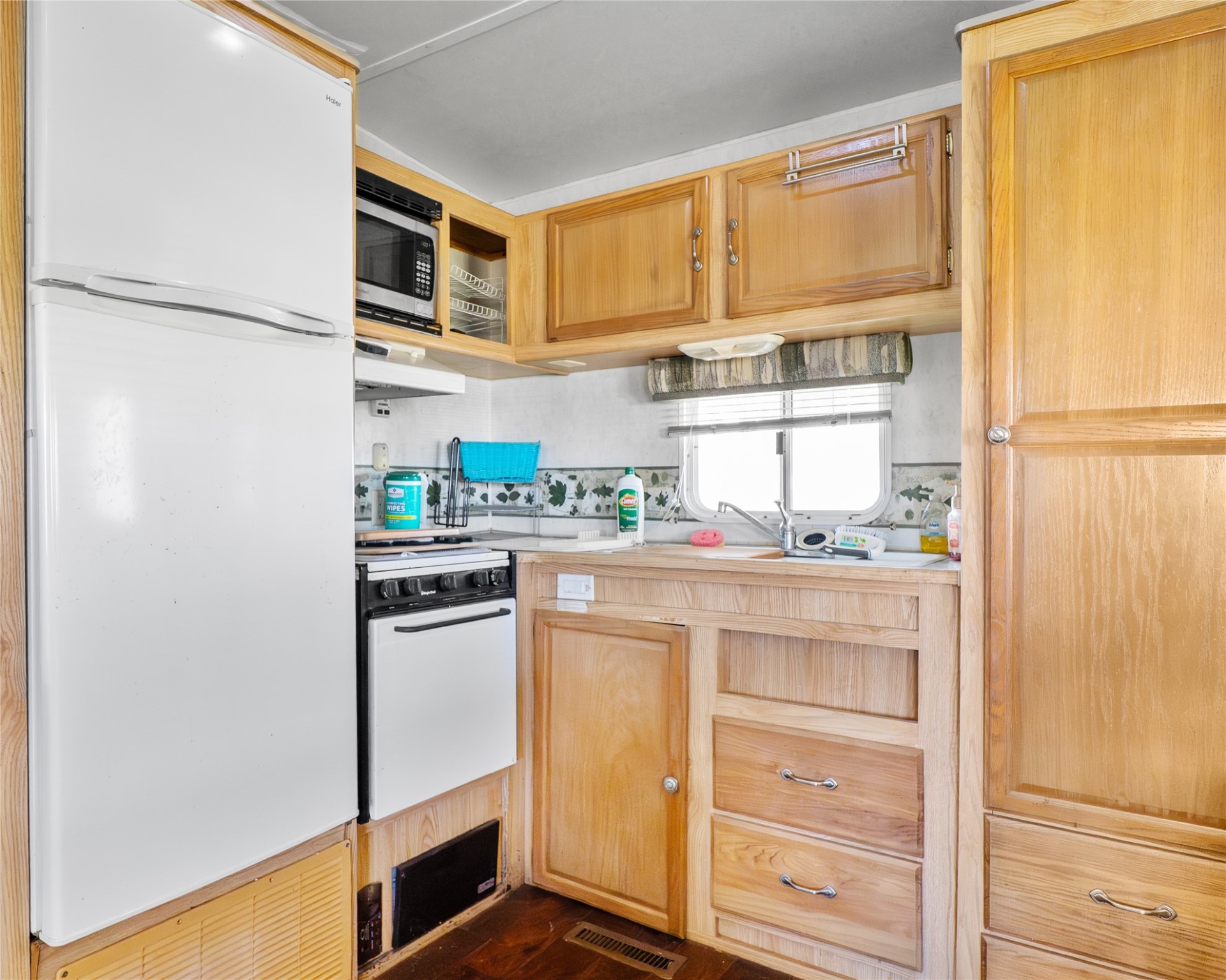 14507 Chimaera Road Sargent, TX 77414 - Photo 16 of 27 a kitchen with stainless steel appliances a refrigerator and cabinets