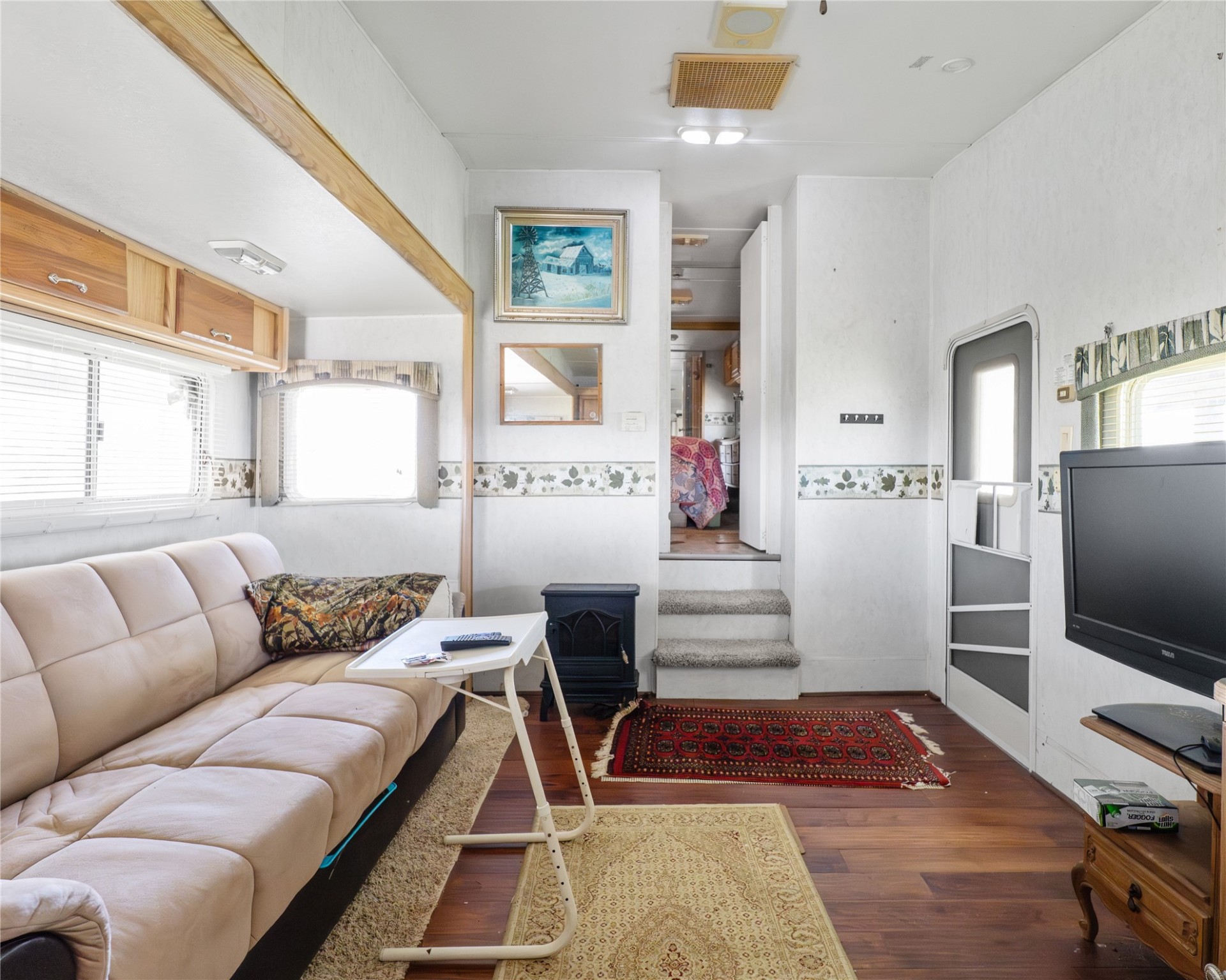 14507 Chimaera Road Sargent, TX 77414 - Photo 17 of 27 a living room with a couch and a flat screen tv