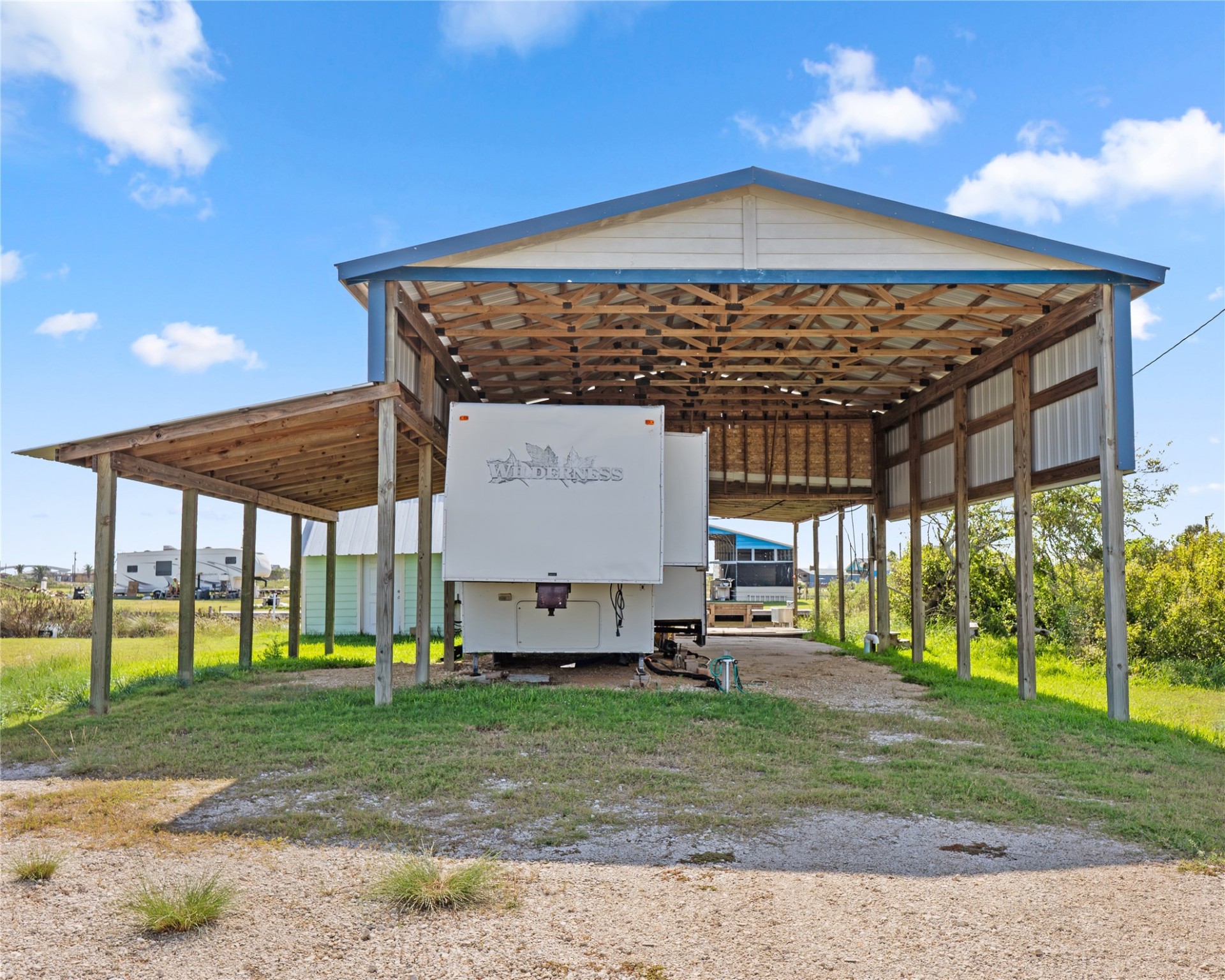 14507 Chimaera Road Sargent, TX 77414 - Photo 27 of 27 a front view of a house with a yard table and chairs