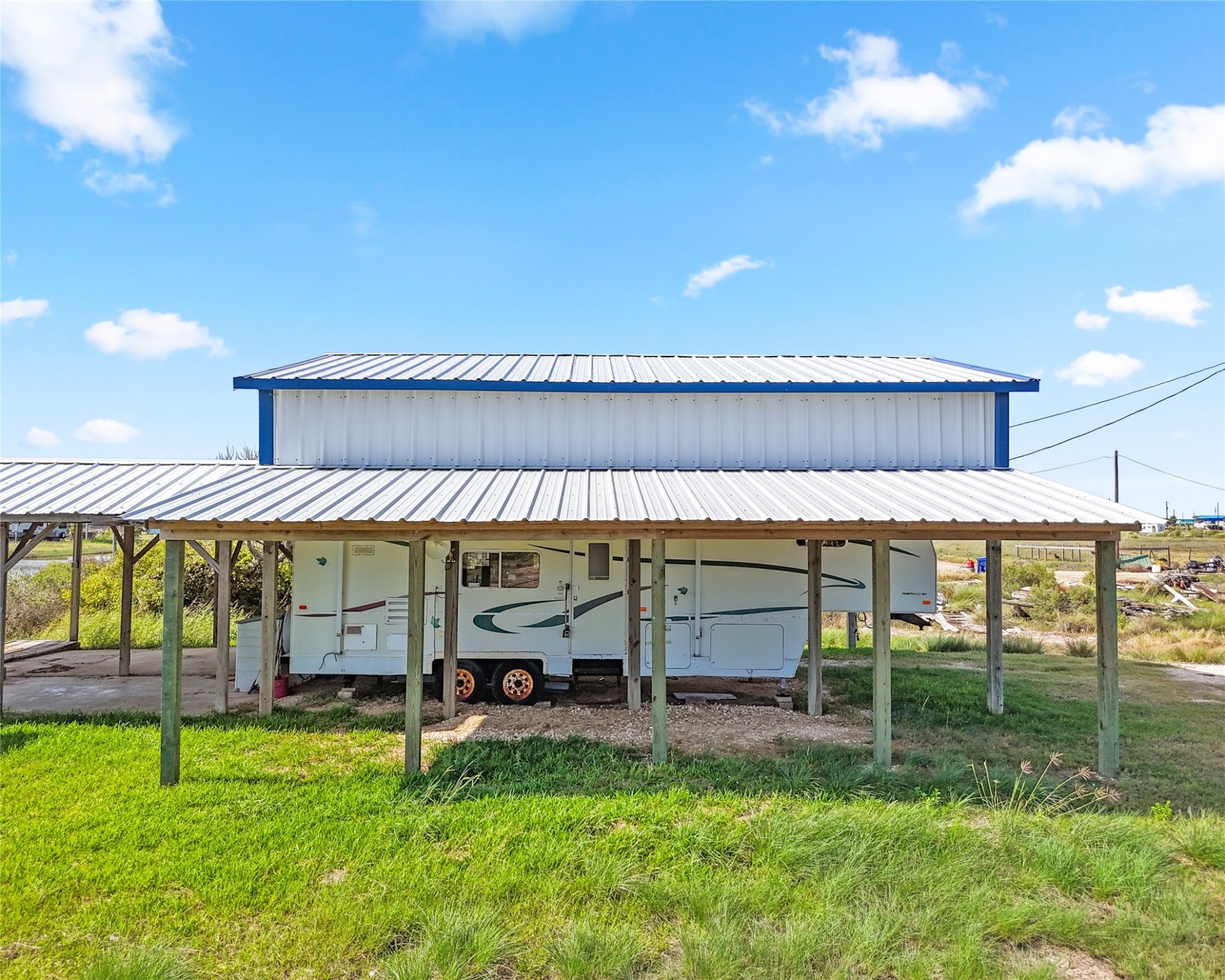 14507 Chimaera Road Sargent, TX 77414 - Photo 5 of 27 a view of a big yard with table and chairs under an umbrella