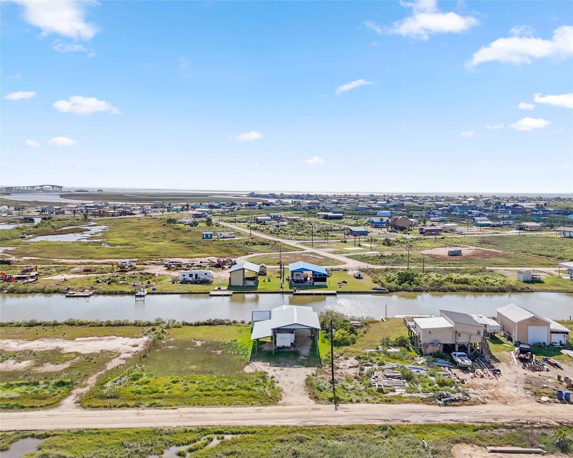 14507 Chimaera Road Sargent, TX 77414 - Photo 6 of 27 a view of a lake with houses in the back